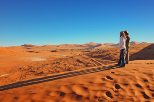 Frauen genießen die Aussicht auf die Dünen in der Namib Wüste. Exklusive Afrika Reise und maßgeschneiderte Privatreise im südlichen Afrika mit persönlicher Betreuung durch SALT Concepts.